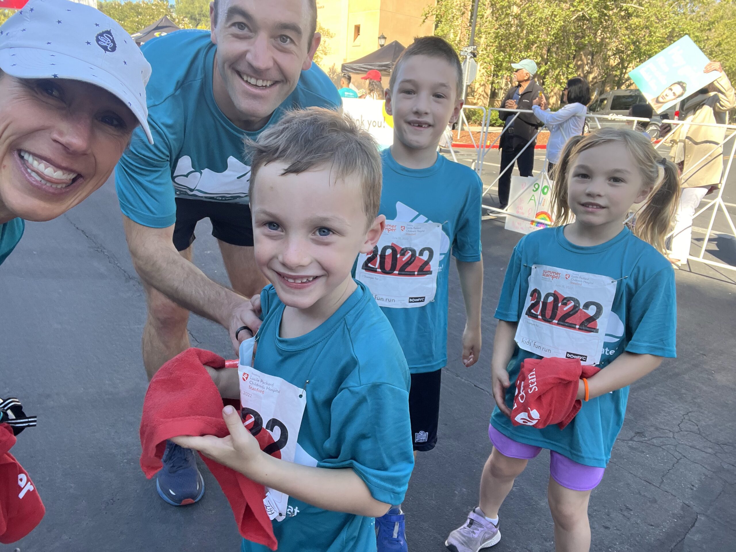 Siblings Matthew, Kate, and Alex pose with their parents at Summer Scamper.