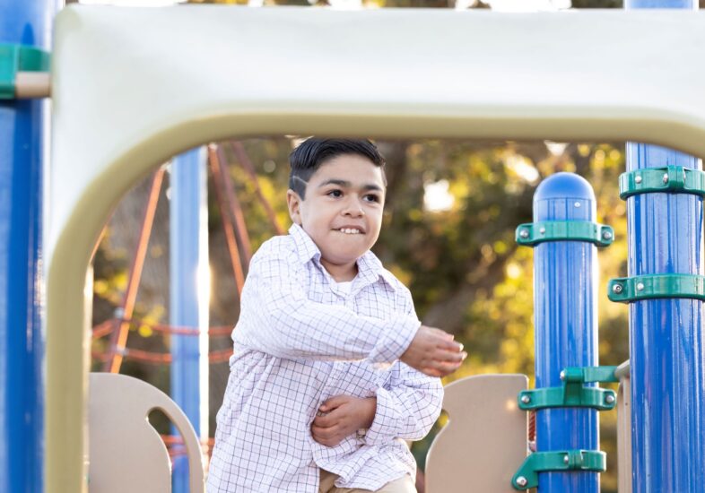 Patient Hero playing on play structure.