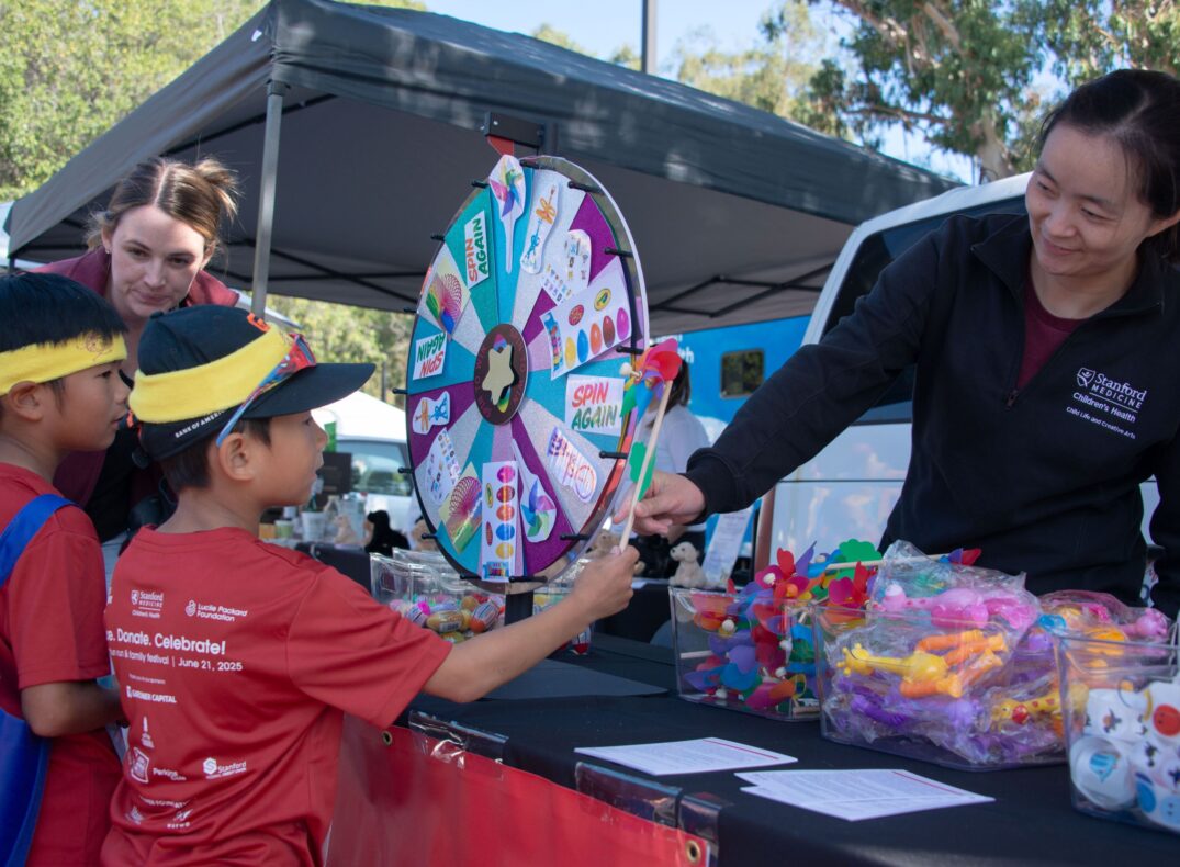 A child spins the wheel in the Family Festival at Summer Scamper.